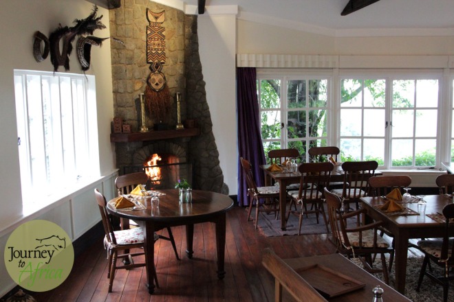 The dining room with large windows  and beautiful fireplace. 
